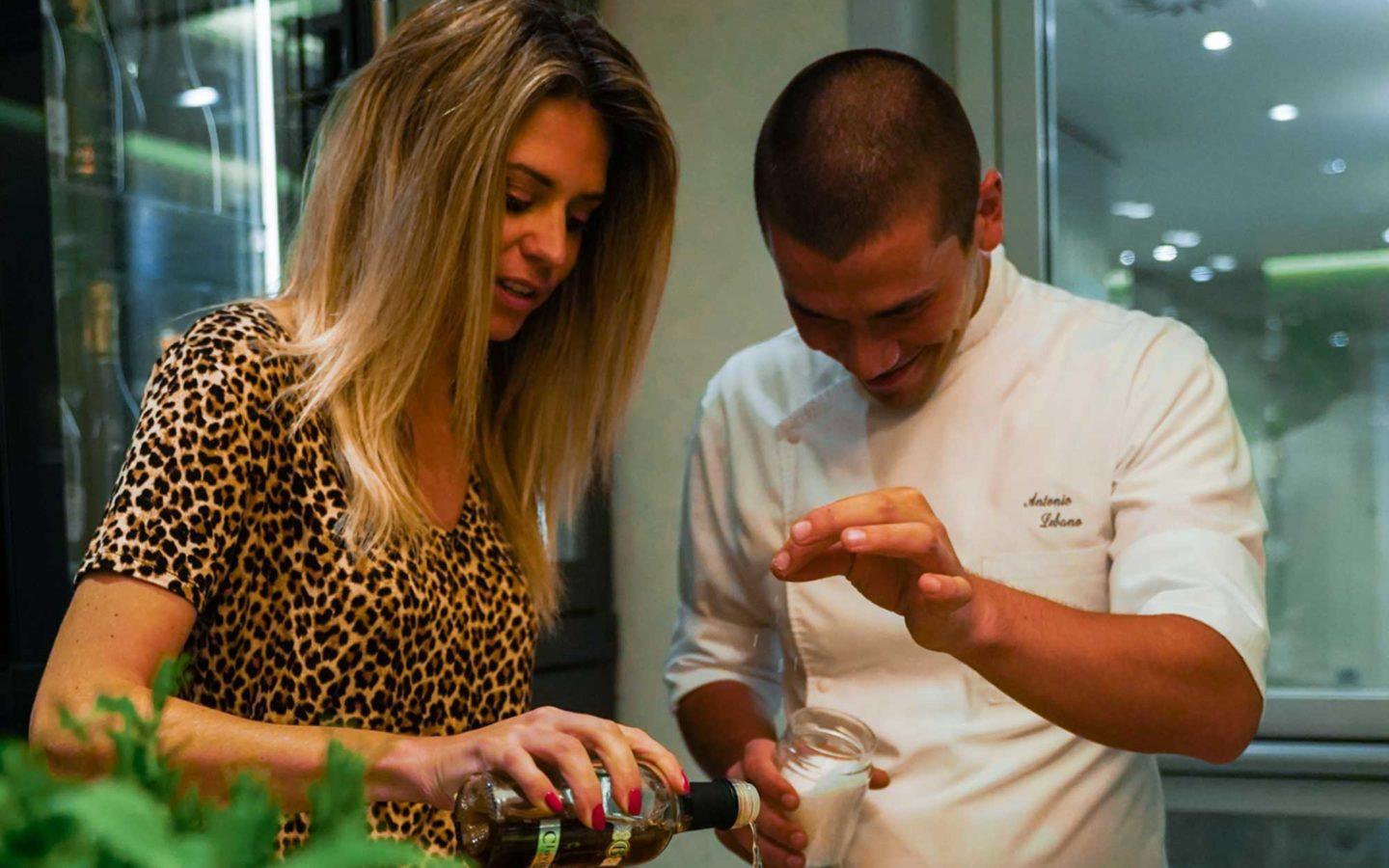 woman with long blonde hair and leopard print shirt cooking with short-haired chef in white shirt